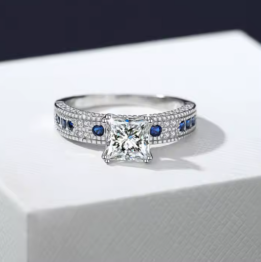 Royal Sapphire: 1.2 Carat Princess Cut Moissanite Ring with Sapphire-Like Accents